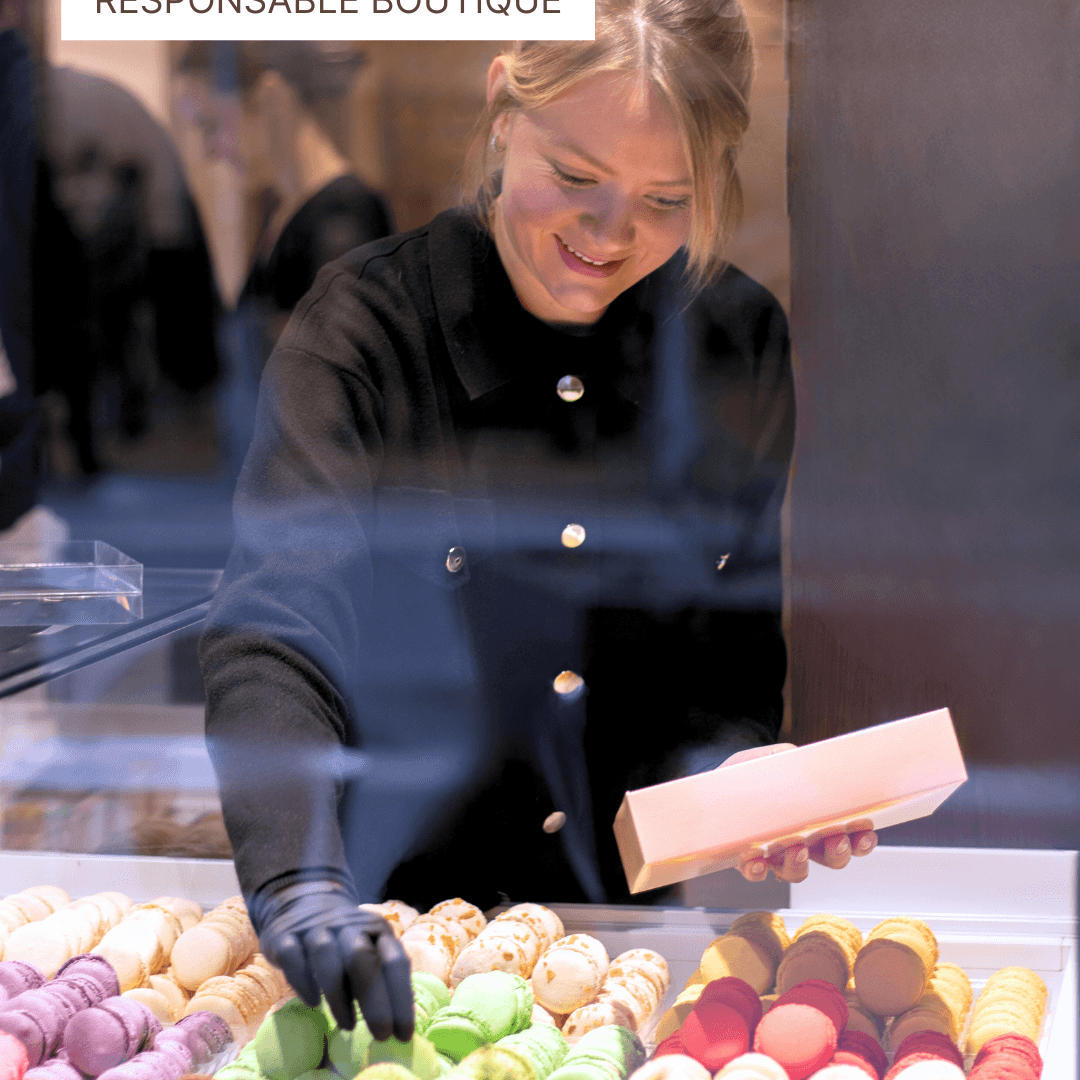 Responsable boutique préparant une boîte de macarons colorés en pâtisserie