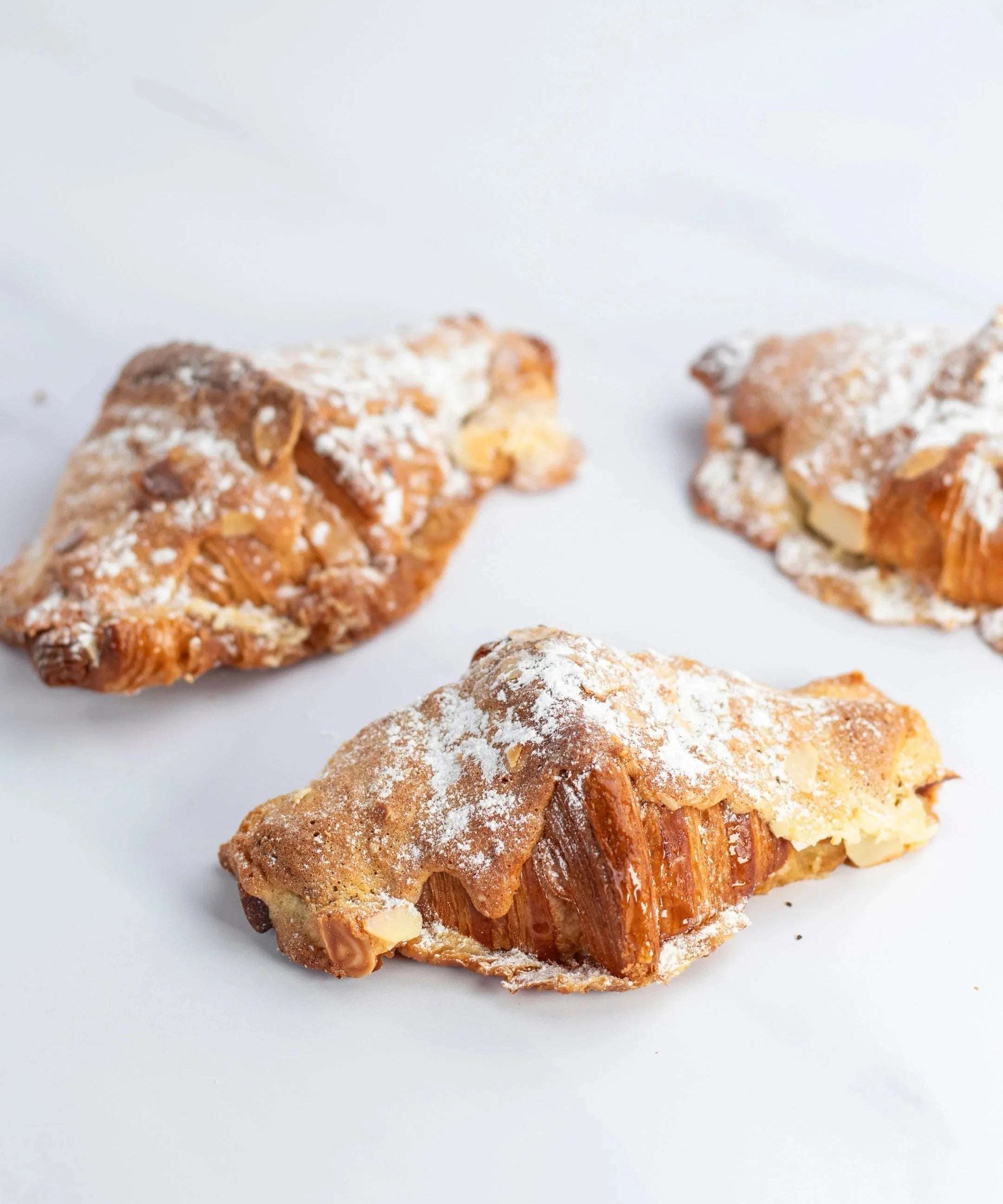 Trois pains au chocolat amande Maison Vatelier saupoudrés de sucre glace.