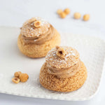 Deux Paris Brest Maison Vatelier garnies de crème praliné et décorées de noisettes.