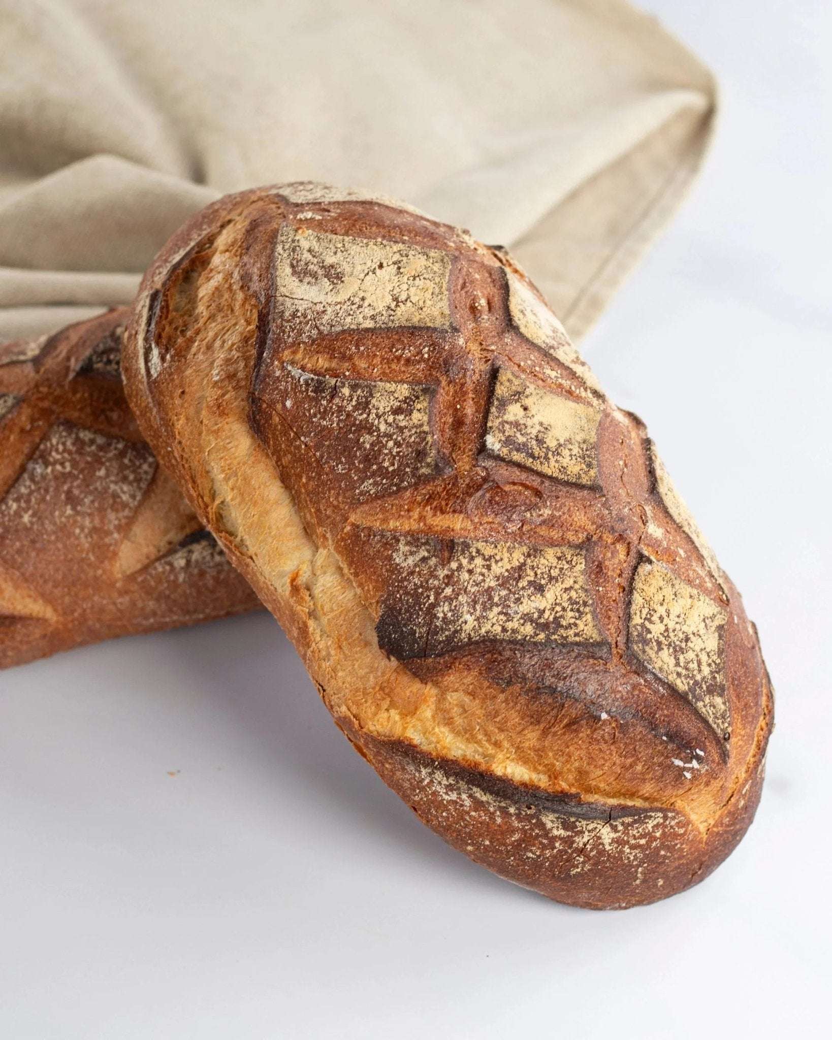 Pain artisanal Polka de Maison Vatelier avec croûte dorée et scarifications géométriques.